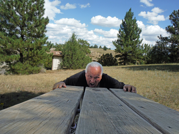 pretending food was rolling down the picnic table and into his mouth